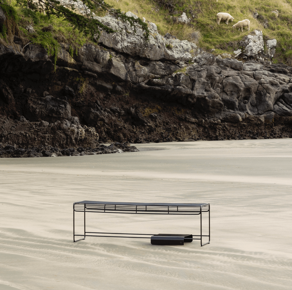 Wire furniture bench, black on the beach