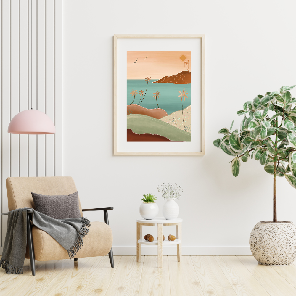 room setting with a pink ceiling lamp over hanging a tan chair with black wood arms and brown throw and cushion, on the wall is a  tropical surreal scene of a beach in ochre, green, terracotta and sand in a wooden frame. There is also a small coffee table with two white pots with plants and a larger treen plant in a white pot