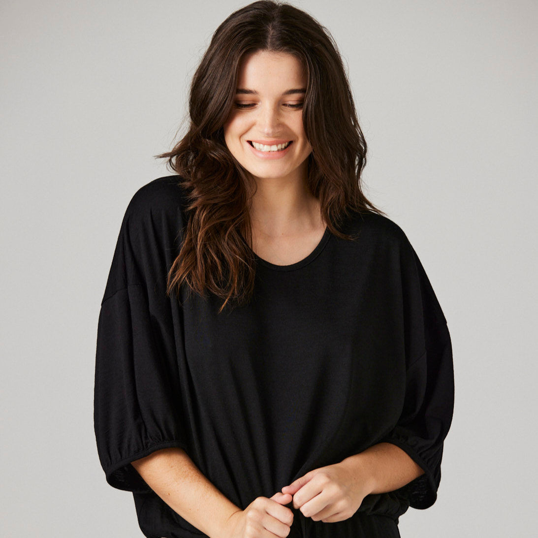 Black merino loungewear top with mid length sleeves on dark haired model