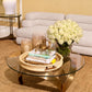 Brass Crab Object from Eichholtz sitting on top of a stack of books on a glass coffee table.