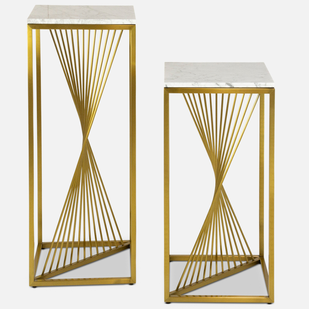 two Giro pedestals side by side with a marble top and gold, twisted spokes in a gold box frame
