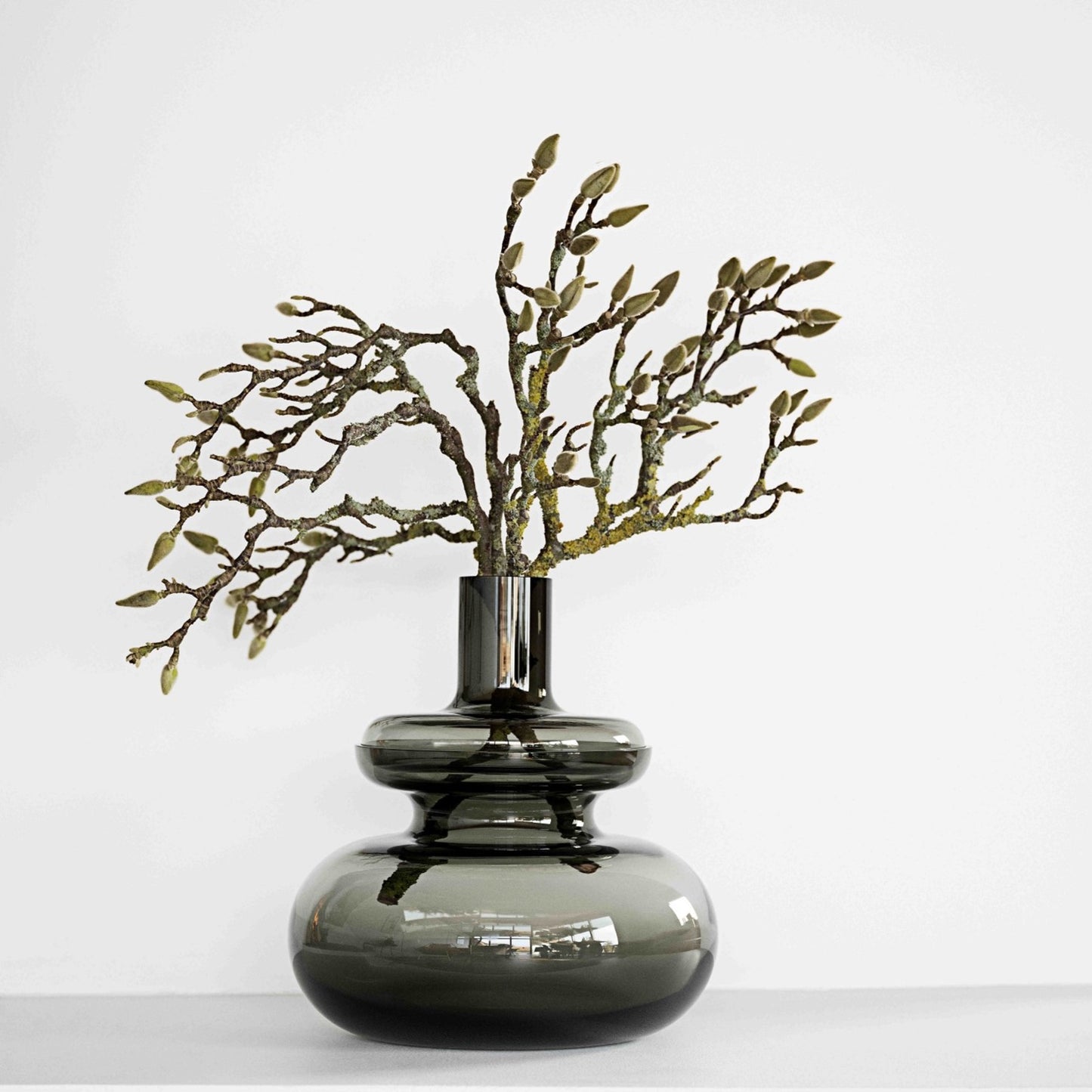 Inu Vase in smoke grey with a budding branch
