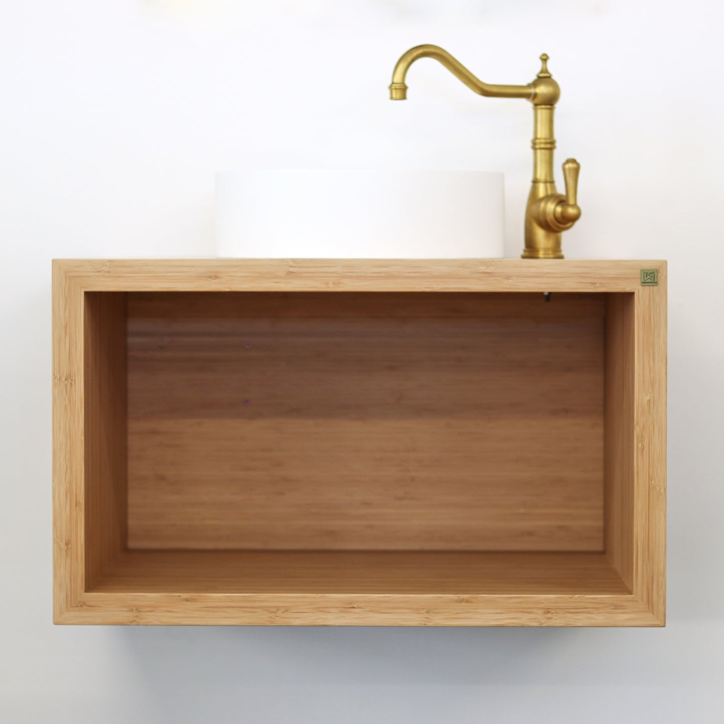 Open square oak cube that is a vanity with an antique brass tap and white sink