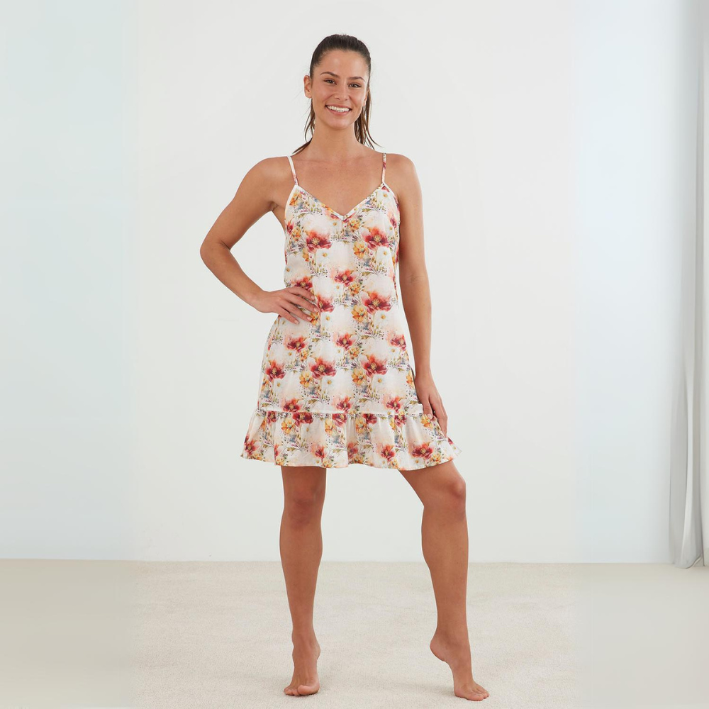 Model wearing the Maddie nightie with red, yellow and green floral print with a frill hem