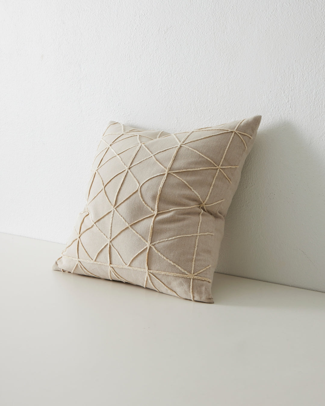 geometric patterned square cushion in cream