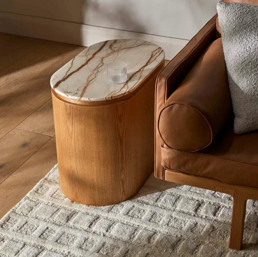 Marble top oval solid wood side table in light coloured wood with cream and brown veining marble top
