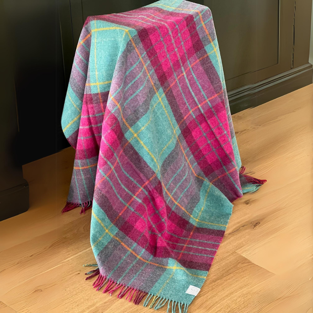 Saltburn New Zealand Wool Throw in Cerise and Aqua check draped over a stool