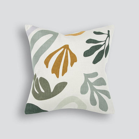 stylised leaves in greens and ochre on a plain cream background in the ariana cushion