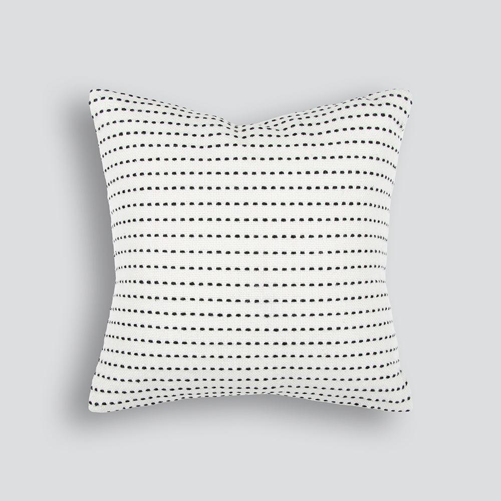 broken black stripe on a white outdoor cushion
