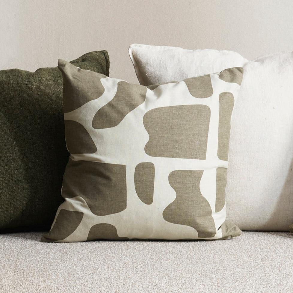 Harper cushion with cream back ground and abstract olive sploges from the Baya Collection