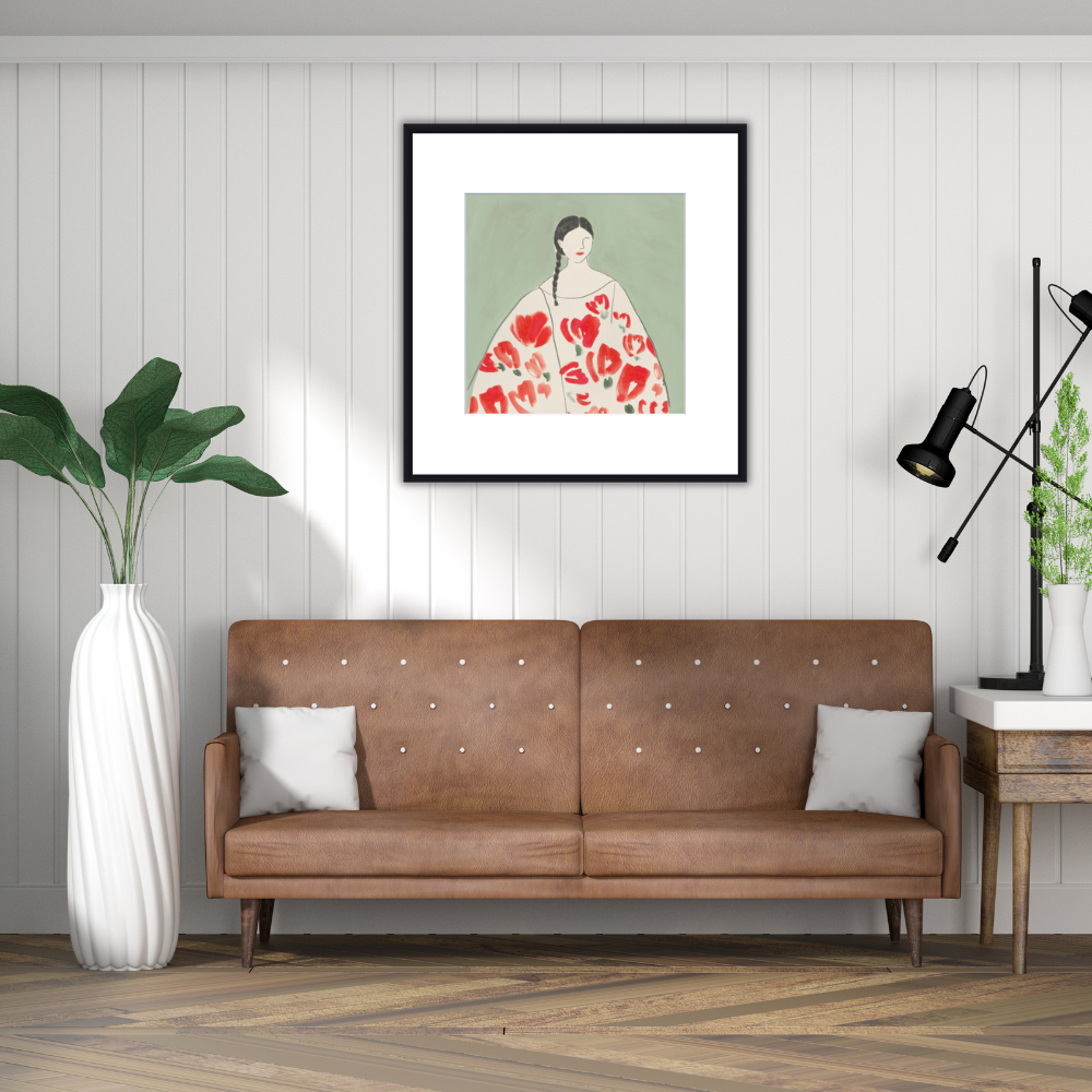 Floral Woman II painting by Lilly K. A japanese stylised female in white gown with orange floral images. This painting is hanging above a brown leather couch against a white shiplamp wall wiht a white tall face to one side and a wooden table on the other with black desk lamps